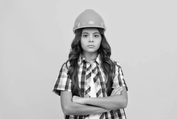 child wear helmet for building. protection and safety. kid education. on construction site. improve your childhood. future engineer. workers day. making repairs. serious teen girl in hard hat.