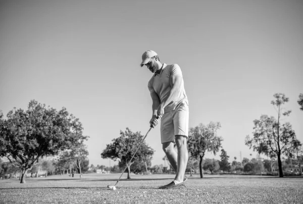 professional sport outdoor. male golf player on professional golf course. portrait of golfer in cap with golf club. people lifestyle. sportive man playing game on green grass. summer activity.