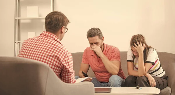 sad couple at psychologist session. family therapy. man and woman talk to social worker. interpersonal relations. life coach. visiting sexologist. lawyer helps with marriage contract. misunderstanding