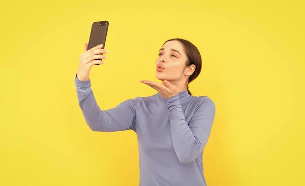 woman blogger use smartphone. video call online. vlog with mobile phone. kiss. businesswoman making selfie. agile business blogging. modern communication technology.