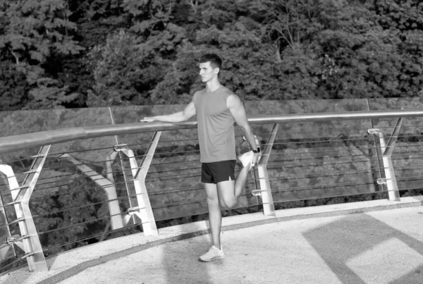 Athletic Guy Sportswear Grab Ankle Hand Stretching Leg Outdoor Training — Zdjęcie stockowe