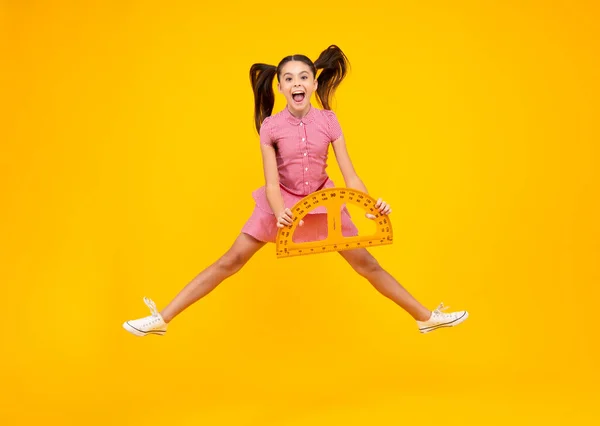 Amazed teenager. Back to school. Teenager school girl on isolated background. Crazy jump, jumping kids. Excited teen schoolgirl with school supplies