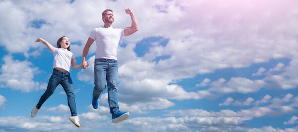 Father and daughter jump on sky, banner with copy space. happy father and daughter jump in sky. freedom.