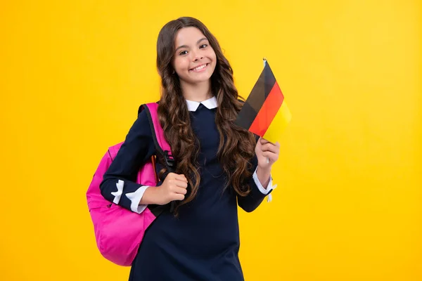 Portrait of school girl with backpack hold germany flag. Education and learning in Germany, Deutschland, deutsche flag. Teen student study in Germany. Language learning