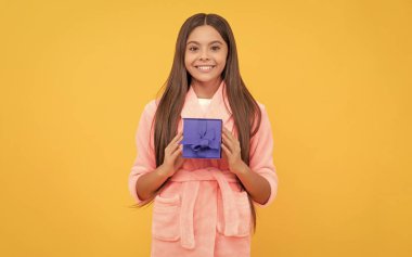 Rahat bir pijama ya da bornoz. Genç kız kendini mutlu hissediyor. çocukluk mutluluğu. Günaydın. Çocuk hediye kutusuyla yumuşak gecelik giyer. Rahat bir uyku tulumu içindeki çocuk. Doğum günü hediyesi. Tatlı rüyalar..