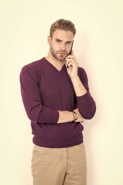 Modern guy in casual fashion style talk on mobile phone isolated on white, communication.