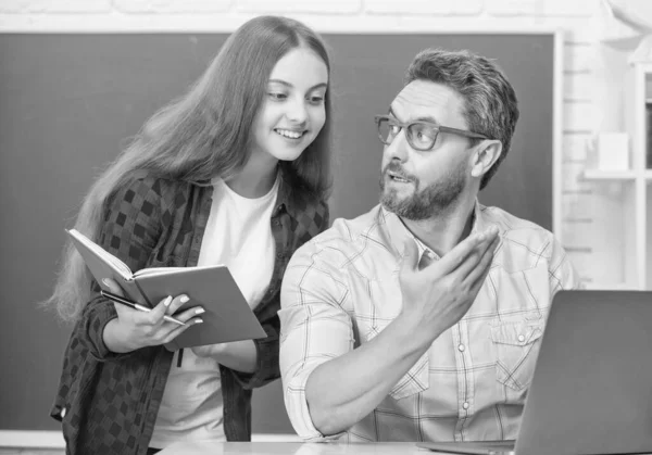 childhood education. cheerful pupil and tutor with laptop. father and teen girl study. private teacher and child hold copybook. family help. dad and daughter use notebook. back to school.