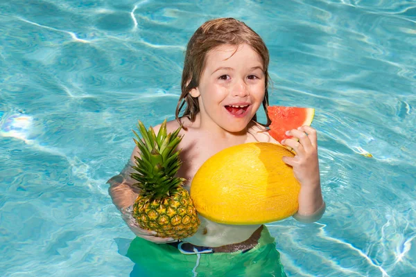 Child in swimming pool playing in summer water. Vacation and traveling with kids. Cute little boy swim on watter pool in the summer. Kids beach fun