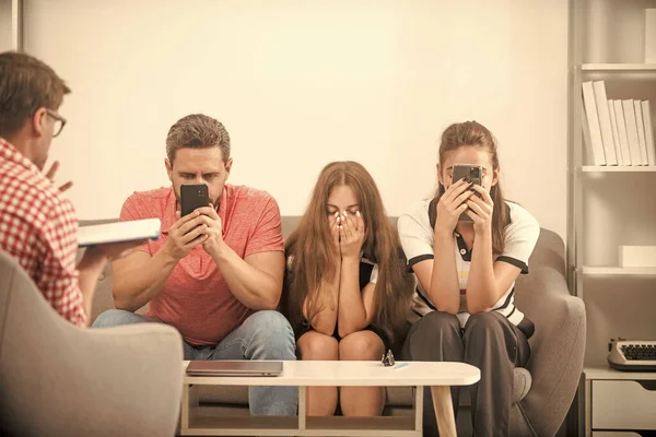 psychologist give family therapy for phone addicted dad mom and daughter girl, addiction.