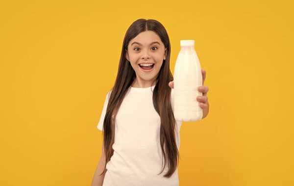 amazed child hold dairy beverage product. girl going to drink milk. healthy lifestyle. chldhood nutrition. drinking per day. dairy food. yogurt for breakfast. kid hold milk bottle. selective focus.