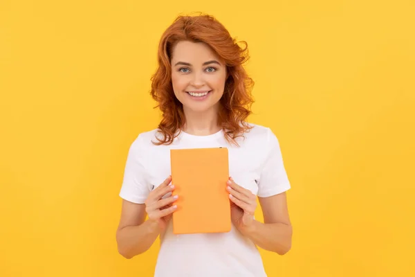 private teacher holding planner. book lover. back to school. education and knowledge. woman reader reading. smiling student on yellow background. girl study with book.