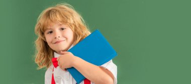 Tahtadaki öğrenci çocuk, afiş fotokopi alanı. Okul sınıfında papyon takan mutlu çocuk, Eylül 'de not defteriyle ders çalışıyor..