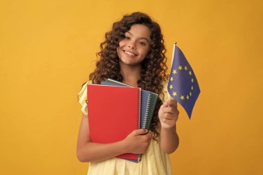 Okul kitaplarıyla mutlu genç kız eğitimi Avrupa Birliği bayrağı ve Schengen vizesi barındırıyor.