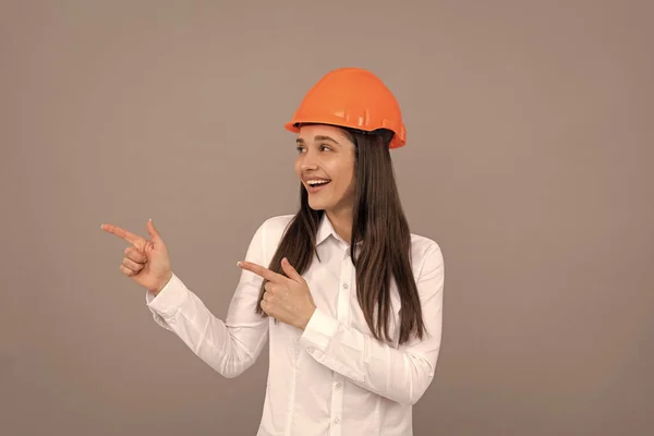 Happy Woman Protective Helmet White Shirt Pointing Finger Aside Directing — Stok fotoğraf