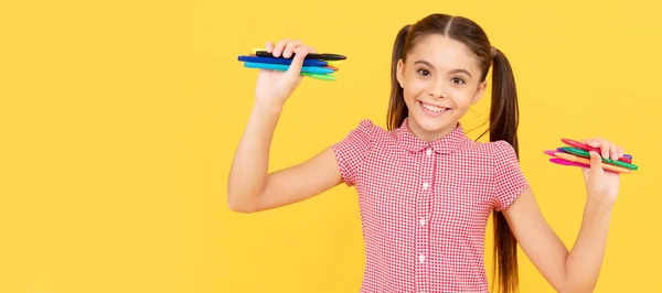 smiling child ready to draw picture. office supplies for school. stationery for painting. Portrait of school girl student, studio banner header. School child pupil face, copy space