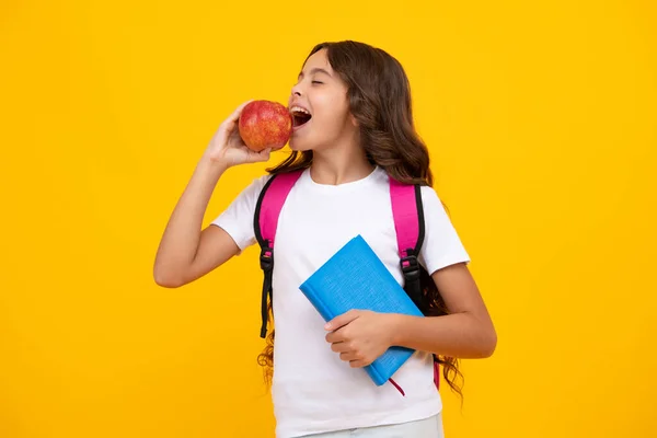 Amazed teen girl. Schoolgirl in school uniform hold apple. School and education concept. Back to school. Schoolchild, teenage student studying. Excited expression, cheerful and glad