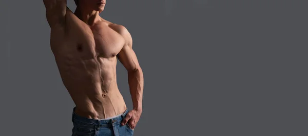 Fit guy with six pack abs torso pose shirtless grey background, muscle. Man sexy bare torso, banner with copy space