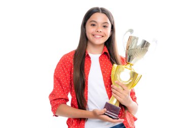 Teenage girl holding a trophy. Kid winner child won the competition, celebrating success and victory, achievement award. Portrait of happy smiling teenage child girl isolated on white