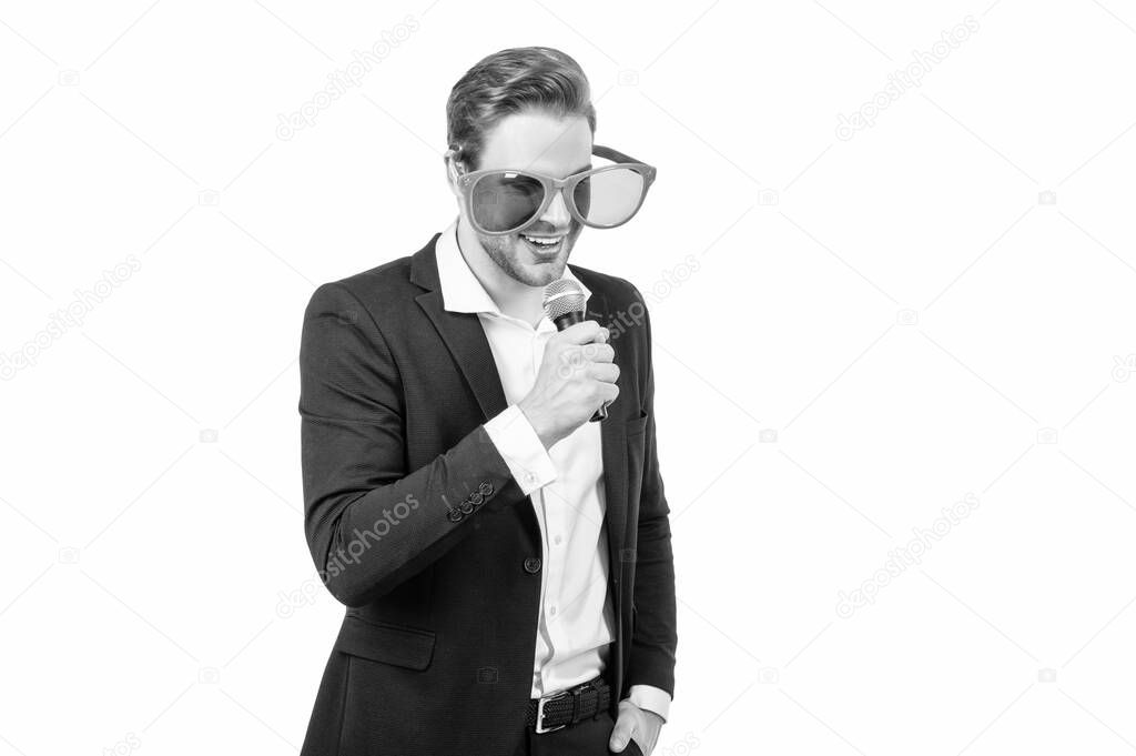 Happy man business speaker in formal suit and funny glasses speak to microphone isolated on white, emcee.