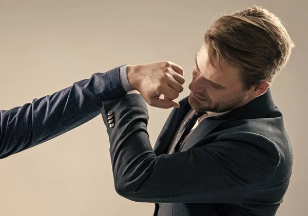 Defending himself from punch to face. Professional man defend punch. Self defence. Physical assault. Workplace aggression. Fighting and conflicting at work.