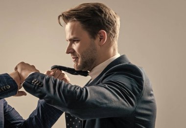 Attacked at work. Manager being pulled by necktie. Fighting and conflict. Professional man fight with coworker. Physical fighting.