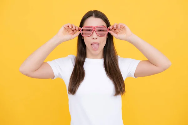 Surprised woman, shocking girl wearing funny glasses on isolated yellow background, Wow face feelings with copy space for advertising