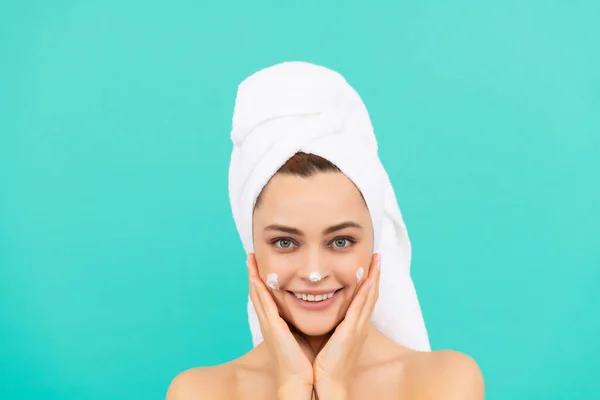 Cheerful Young Lady Applying Face Cream Blue Background — Stockfoto