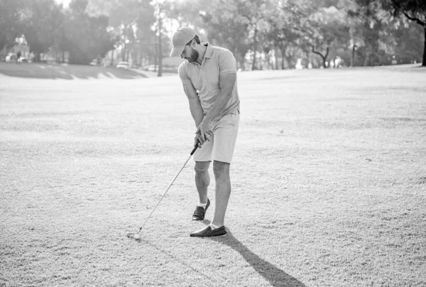 professional sport outdoor. male golf player on professional golf course. portrait of golfer in cap with golf club. people lifestyle. busy man playing game on green grass. summer activity.