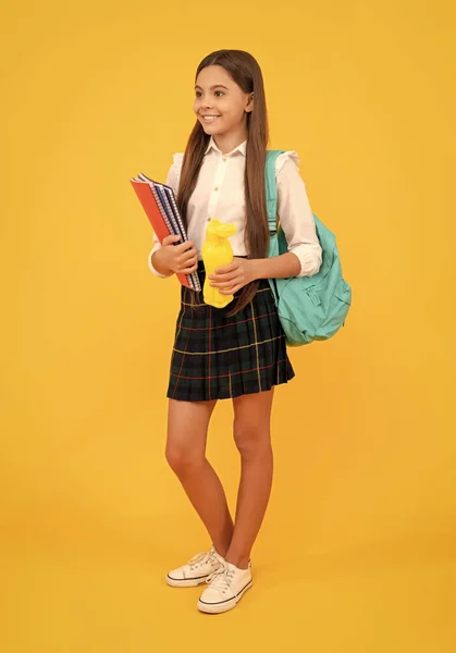 cheerful kid going on lunch. teenager student hold planner notebook. education in high school. schoolgirl with apple and water bottle. back to school. teen girl ready to study. happy childhood.
