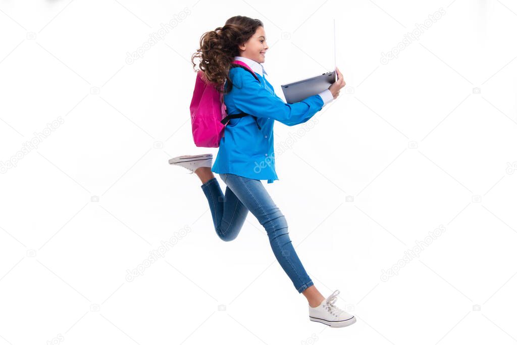 Run and jump, jumping kid. Schoolgirl in school uniform with laptop. Schoolchild, teen student on white isolated background