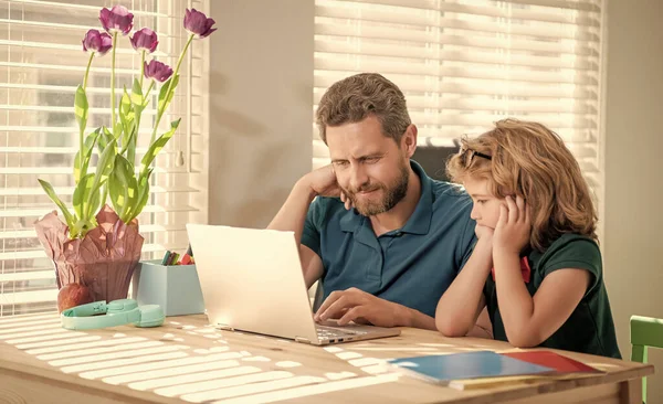 webinar video lesson. online education on laptop. homeschooling and elearning. back to school. cheerful father and son use modern technology at home. family blog. boy do homework with private teacher.