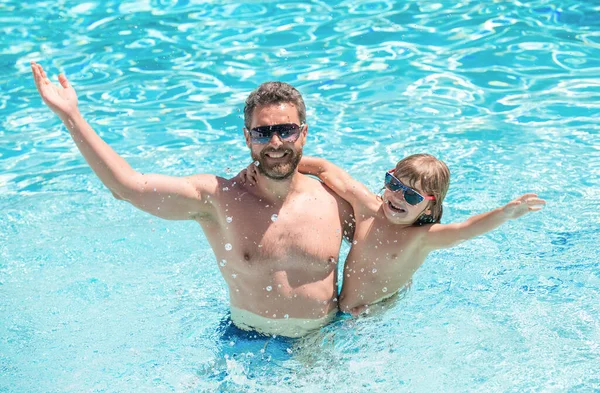 happy family of daddy and child having fun in summer swimming pool, free time.