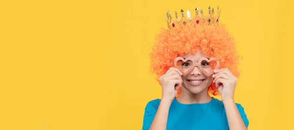 nice look. egocentric kid in clown wig and crown. imagine herself princess. funny child. Funny teenager child in wig, party poster. Banner header, copy space