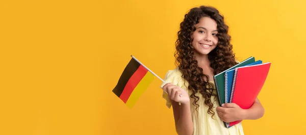 german language. child hold flag. back to school. teen girl study in germany. Portrait of schoolgirl student, studio banner header. School child face, copyspace