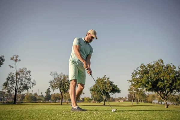 professional sport outdoor. male golf player on professional golf course. portrait of golfer in cap with golf club. people lifestyle. sportive man playing game on green grass. summer activity.