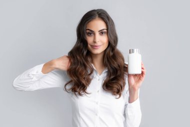 Healthcare and medicine. Portrait of attractive girl holding on bottle pills healthy product over gray background