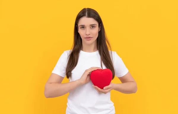 heart day and donation. woman with heart. happy valentines day. be my valentine. girl with love symbol on yellow background. love romantic gift. sweetheart. valentines sale.