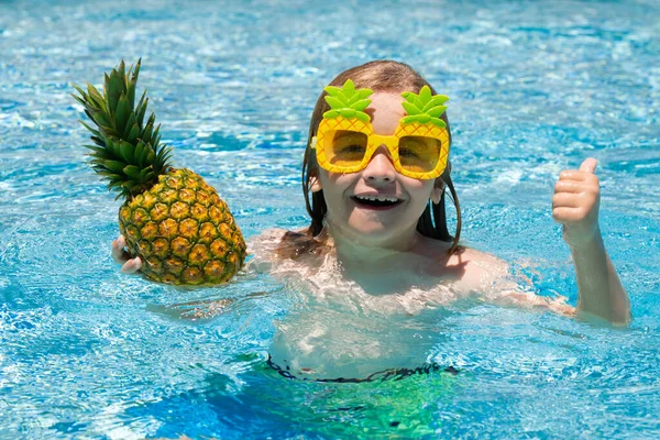 Child playing in the swimming pool. Summer kids activity