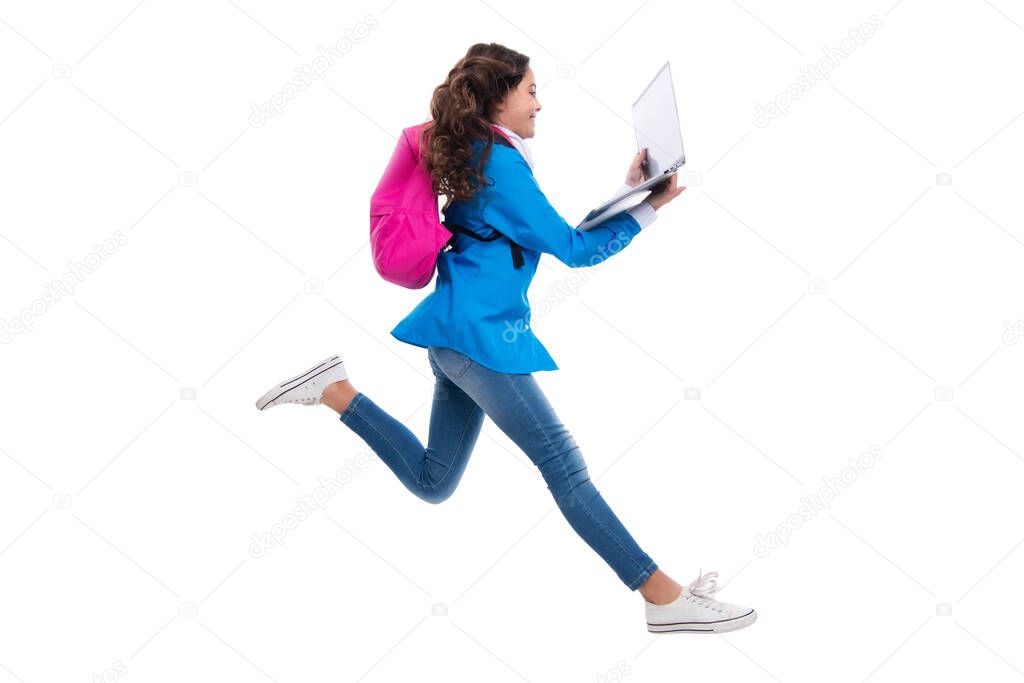 Schoolchild, teenage student girl with laptop on white isolated studio background. Run and jump, jumping kid. Children school and education concept