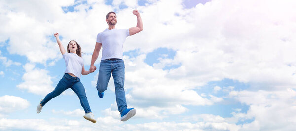 Father and daughter jump on sky, banner with copy space. happy father and daughter jump in sky. happiness.