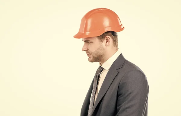 Engineering with value. Profile portrait of engineer. Civil engineer side-face. Construction man in hardhat and suit. Serious constructor, copy space.