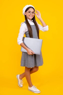 Young student school girl, studying with laptop computer. E-learning concept. Happy face, positive and smiling emotions of teenager schoolgirl