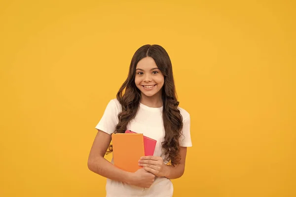 agenda. happy child hold notebook. teen girl with notepad. kid planning her work. student prepare for exam. schoolgirl do homework. school report. pupil hold planner. back to school. education.