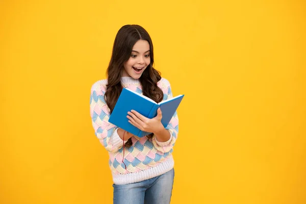 Excited face. Teen girl pupil hold books, notebooks, isolated on yellow background, copy space. Back to school, teenage lifestyle, education and knowledge. Amazed expression, cheerful and glad