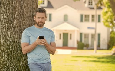 Emlakçı akıllı telefondan çalışır. Kira ya da yeni bir ev al. Ev sigortası. Emlak sigortası tanıtımı. kopyalama alanı. İpotek sigortacısı. Amerikan satış müdürü. Evdeki emlakçı satılık..