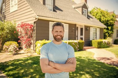 amazed unshaven guy crossed hands near house, realtor.