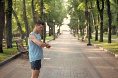 man checking time on smartwatch, copy space.