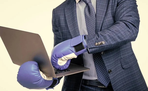 cropped businessman man in suit and boxing gloves holding laptop isolated on white, cyber bulling.