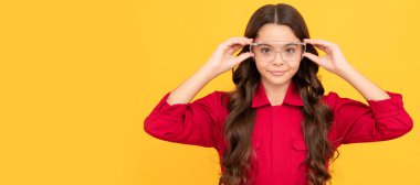 smiling teenager girl wearing protective glasses, eye protection. Child builder with protective glasses horizontal poster design. Banner header, copy space