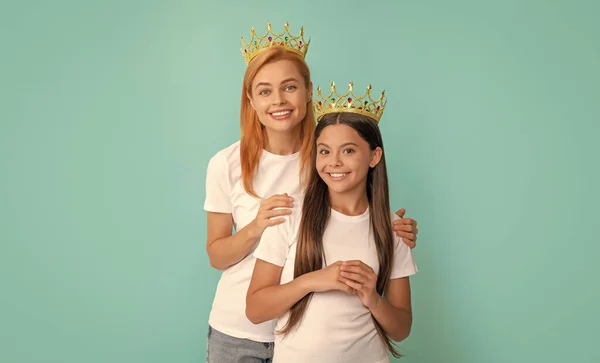 Make sure youre the prom queen. Beauty queen and princess. Happy mother and daughter child smile in crowns. Selfish woman and girl.
